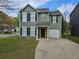Charming two-story home featuring green shutters, a one-car garage, and a well-manicured front lawn at 6718 Roscommon Dr, Austell, GA 30168