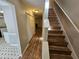 Inviting hallway with wood-look flooring and stairs leading to the upper level of the home at 6718 Roscommon Dr, Austell, GA 30168