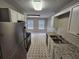 Well-lit kitchen offering modern appliances, white cabinets, and seamless access to the dining area at 6718 Roscommon Dr, Austell, GA 30168