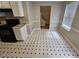 Eat-in kitchen showcasing black appliances, white cabinets, and access to the upper level at 6718 Roscommon Dr, Austell, GA 30168