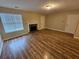 Spacious living room featuring sleek flooring, a fireplace, and multiple entry points for convenience at 6718 Roscommon Dr, Austell, GA 30168
