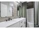 Bright bathroom featuring a double sink vanity with white marble countertops and modern faucets at 1153 Haven Brook Ln, Brookhaven, GA 30319