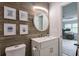 Modern bathroom featuring a round mirror, stylish wall art and wood walls at 1153 Haven Brook Ln, Brookhaven, GA 30319