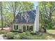 Charming home with a well-manicured lawn, lush landscaping, black shutters and a classic chimney at 1153 Haven Brook Ln, Brookhaven, GA 30319