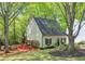A charming house with fresh landscaping, a green lawn, and trees surrounding the home at 1153 Haven Brook Ln, Brookhaven, GA 30319