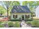 Attractive home featuring lush landscaping, black shutters, and a path leading to the front door at 1153 Haven Brook Ln, Brookhaven, GA 30319