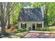 Attractive home featuring lush landscaping, black shutters, and a walkway leading to the front door at 1153 Haven Brook Ln, Brookhaven, GA 30319