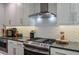 The kitchen features stainless steel appliances, a gas range, subway tile backsplash, and gray countertops at 1153 Haven Brook Ln, Brookhaven, GA 30319