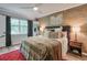 Comfortable main bedroom with hardwood floors, ceiling fan, and a feature wall at 1153 Haven Brook Ln, Brookhaven, GA 30319