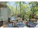 Backyard patio with comfortable seating, string lights, and privacy landscaping at 1153 Haven Brook Ln, Brookhaven, GA 30319