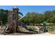 A fenced-in playground with a tall play structure including a slide and castle at 1153 Haven Brook Ln, Brookhaven, GA 30319