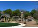 A playground with swings, a play structure, and a covered picnic table at 1153 Haven Brook Ln, Brookhaven, GA 30319