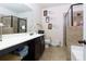Bathroom featuring a shower with glass door, vanity with storage, and decorative accents at 257 Ironwood Dr, Stockbridge, GA 30281