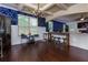 Open-concept dining room with elegant coffered ceiling, dark wood floors, and modern lighting at 257 Ironwood Dr, Stockbridge, GA 30281