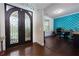 Elegant entryway featuring a decorative door, hardwood floors, and a bright workspace at 257 Ironwood Dr, Stockbridge, GA 30281
