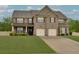 Handsome two-story brick home with a well-maintained lawn and long driveway at 257 Ironwood Dr, Stockbridge, GA 30281