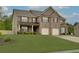 Charming two-story brick home with a well-manicured lawn and a two-car garage at 257 Ironwood Dr, Stockbridge, GA 30281