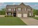 Classic brick home with an attached two-car garage and meticulously kept lawn at 257 Ironwood Dr, Stockbridge, GA 30281