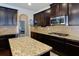 Kitchen featuring granite countertops, dark wood cabinets, and stainless steel appliances at 257 Ironwood Dr, Stockbridge, GA 30281
