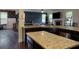 Open kitchen featuring granite countertops, dark wood cabinets, and stainless steel appliances at 257 Ironwood Dr, Stockbridge, GA 30281