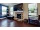 Living room features a stone fireplace with a large TV above the mantle and windows for ample natural light at 257 Ironwood Dr, Stockbridge, GA 30281