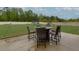 Backyard patio with outdoor dining set overlooking the lawn at 257 Ironwood Dr, Stockbridge, GA 30281