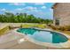 Backyard features a private in-ground pool, lounge furniture, and beautiful landscaping at 257 Ironwood Dr, Stockbridge, GA 30281