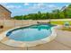 Backyard view showcasing a private pool, lush greenery, and outdoor seating at 257 Ironwood Dr, Stockbridge, GA 30281