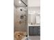 Elegant bathroom featuring a glass shower with pebble floor, and dual vanity sinks with granite countertop at 375 Highland Ne Ave # 508, Atlanta, GA 30312