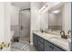 Modern bathroom with a double vanity, glass-enclosed shower, and tile accents at 375 Highland Ne Ave # 508, Atlanta, GA 30312