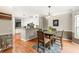 Open dining room with hardwood floors, a modern chandelier and access to kitchen at 375 Highland Ne Ave # 508, Atlanta, GA 30312