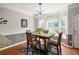 Dining area featuring a modern table, hardwood floors, and large windows at 375 Highland Ne Ave # 508, Atlanta, GA 30312