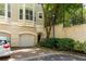 Home exterior featuring a garage, brick driveway, and meticulously maintained landscaping at 375 Highland Ne Ave # 508, Atlanta, GA 30312