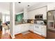Well-lit kitchen with white cabinetry, stainless appliances, and hardwood floors at 375 Highland Ne Ave # 508, Atlanta, GA 30312