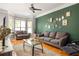 Cozy living room with hardwood floors, green accent wall, and modern decor at 375 Highland Ne Ave # 508, Atlanta, GA 30312