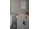Bathroom with white cabinets, modern hardware, white countertop, and toilet at 4907 Windsor Downs Dr, Decatur, GA 30035
