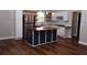 Modern kitchen with stainless steel appliances, white cabinets, and a stylish island at 4907 Windsor Downs Dr, Decatur, GA 30035