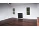 Bright living room featuring hardwood floors, a fireplace, and large windows at 4907 Windsor Downs Dr, Decatur, GA 30035