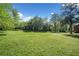 Vast backyard with mature trees and a lush green lawn at 630 Cambridge Dr, Marietta, GA 30066