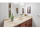 Bathroom with a granite vanity top, dark wood cabinets, and decorative plants at 630 Cambridge Dr, Marietta, GA 30066