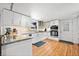 Modern kitchen with white cabinets, granite countertops, stainless steel appliances, and hardwood floors with recessed lights at 630 Cambridge Dr, Marietta, GA 30066