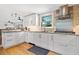 Beautiful white cabinets, stainless steel appliances, granite counters, recessed lighting and hardwood floors in the kitchen at 630 Cambridge Dr, Marietta, GA 30066