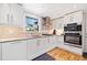 Bright, updated kitchen with white cabinetry, stainless steel appliances, subway tile backsplash, and hardwood flooring at 630 Cambridge Dr, Marietta, GA 30066