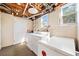 Functional laundry area with washer, dryer, and ample space, located in the basement at 630 Cambridge Dr, Marietta, GA 30066