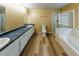 Bright bathroom features double vanity, separate shower, tub, and modern commode at 1960 Banks Way, Atlanta, GA 30349
