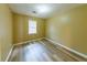 Cozy bedroom with light-colored walls, a window for natural light, and laminate flooring at 1960 Banks Way, Atlanta, GA 30349