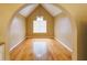 Open dining room with a vaulted ceiling, large window, hardwood floors, and decorative lighting fixture at 1960 Banks Way, Atlanta, GA 30349