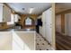 Well-lit kitchen featuring white cabinets, granite countertops, tiled floors, and a cozy breakfast nook area at 1960 Banks Way, Atlanta, GA 30349