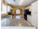 Bright kitchen with white cabinets, granite countertops, black appliances, and access to dining area at 1960 Banks Way, Atlanta, GA 30349