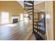 Bright living room with fireplace, light wood floors, and a unique spiral staircase leading to the upper level at 1960 Banks Way, Atlanta, GA 30349